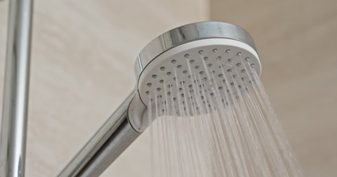 Water flow from shower head in bathroom