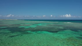 Aerial Drone Video of waves breaking on the coral barrier reef at the caribbean