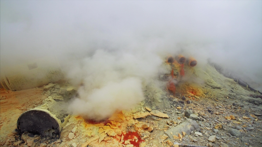 Close view of toxic smelly yellow fumes from burning sulphur at Ijen volcano in East Java, Indonesia. Morning