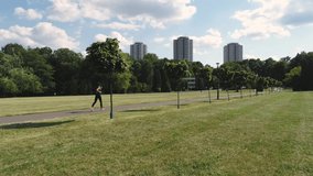 Drone view of young woman running in the park 