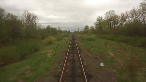 train POV railway track, rails, View from moving train window Landscape Mountain Village Moody Cinematic Dramatic Shot