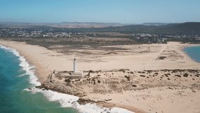 Aerial view of Cape Trafalgar lighthouse,  Cadiz, south-west of Spain. Atlantic Ocean, northwest of the Strait of Gibraltar. In 1805 naval Battle of Trafalgar took place here. Pan right video