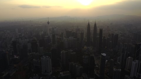 KUALA LUMPUR, MALAYSIA - AUGUST 2019 : 4K aerial footages of Kuala Lumpur city buildings and landmarks including KL Tower and Petronas Twin Tower (KLCC) from a drone during sunset.