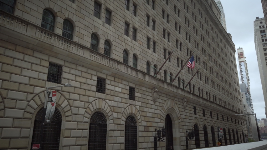 New York, NY / USA - July 23, 2019: Federal Reserve Bank of New York building exterior wide shot in Lower Manhattan New York with US flag. 