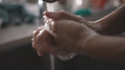 Close up of woman thoroughly washing her hands