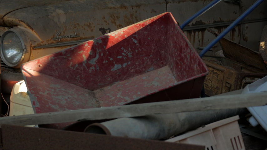 Rusty old car left to degrade in a garage. TILT UP SHOT