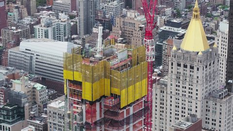 New York, NY, USA. August 1, 2019. New skyscrapers under construction. Construction site with cranes, elevators and scaffolding