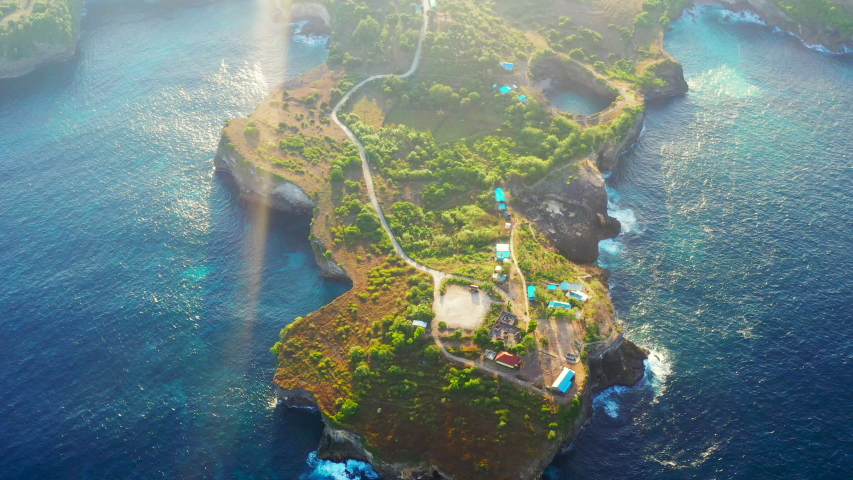 Aerial view by drone 4k camera. Rocky coast with high cliffs, Nusa Penida, Pasih Uug, Broken Beach. Ocean with waves and rocky cliff. Bird eye view