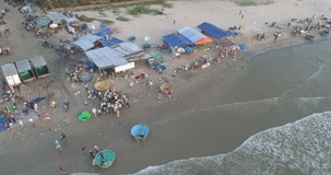 Top view, aerial view fishing harbor market from a drone. Royalty high-quality free stock video footage of market at Mui Ne fishing harbour or fishing village.  