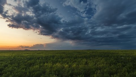 Storm clouds rolling over prairies at sunset 4K time lapse