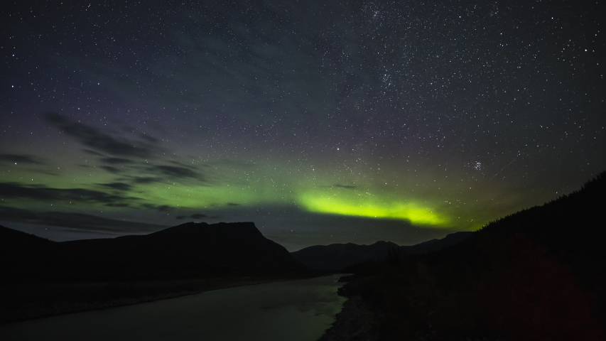 Northern lights and stars above river in the mountains of BC 4K time lapse | Shutterstock HD Video #1035065909