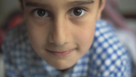 Close-up of a cute little arab boy looking at the camera and smiling