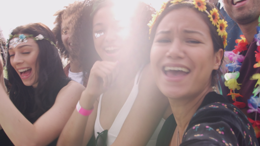 Group Of Young Friends Dancing Behind Barrier Taking Selfie At Outdoor Music Festival  Royalty-Free Stock Footage #1035080810