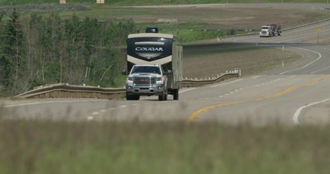 Dunvegan , Alberta / Canada - 06 21 2019: GMC Truck pulls holiday trailer on highway.