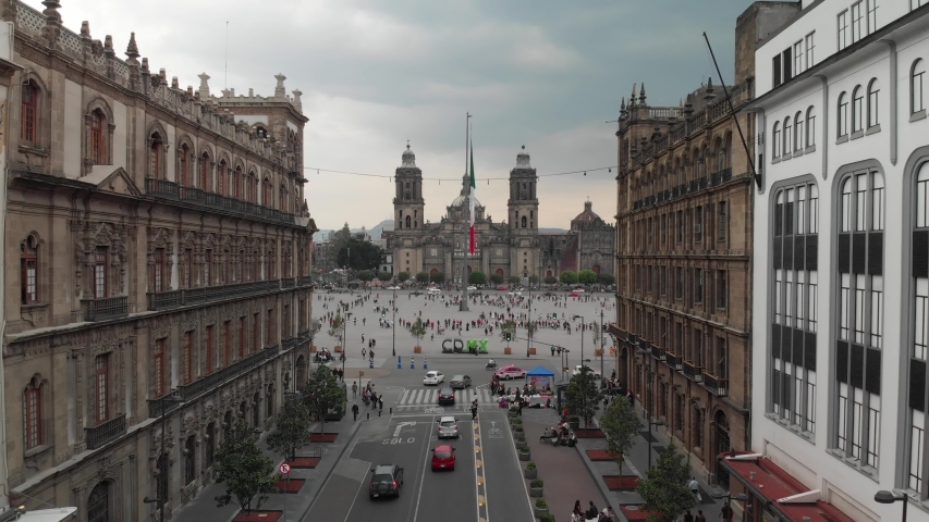 Aerial view of  Mexico City, the Monumental Flag and the Cathedral. Drone flying backwards and ascending. Royalty-Free Stock Footage #1035103559