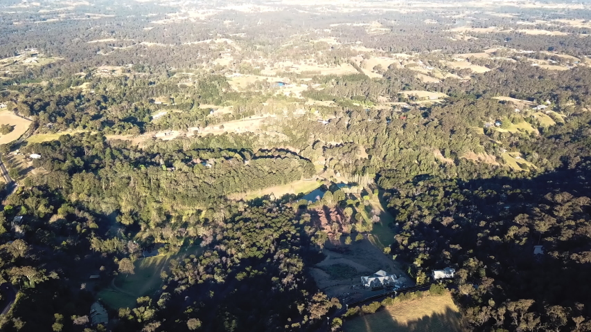 The wooded slopes of the Grose Valley looking towards north western Sydney. Tilting aerial shot from a drone above the farmland near Kurrajong, New South Wales
