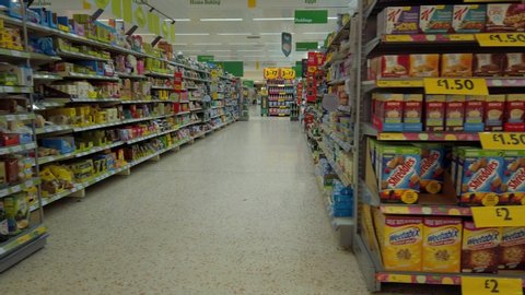 Widnes / United Kingdom (UK) - 06 22 2019: Empty supermarket aisle passing various selection of foods & goods.