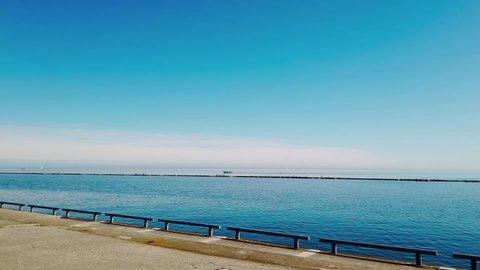 Toronto , ON / Canada - 04 27 2019: Moving cyclist's view of Lake Ontario on a sunny spring day