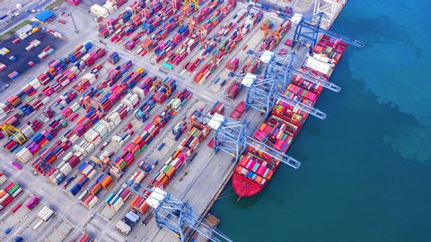 4K Timelapse of modern industrial port with containers from top view or aerial view. It is an import and export cargo port where is a part of shipping dock