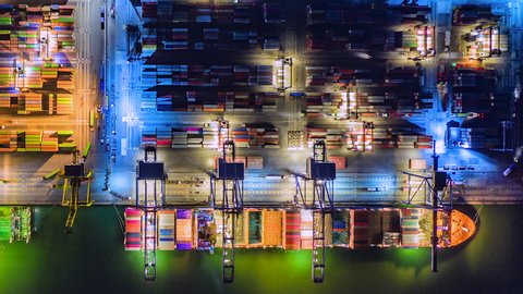 4K Time lapse Night of modern industrial port with containers from top view or aerial view. It is an import and export cargo port where is a part of shipping dock and export products worldwide