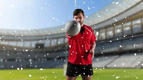 Animation of a Caucasian male rugby player playing with a ball and looking to camera with white confetti falling and a sports stadium in the background - Powered by Shutterstock - Get 15% off with code: PIKWIZARD15