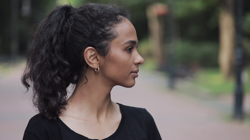 Portrait of Happy Young Preety Musline Girl Turning her Head Smiling and Standing in Park Close Up.