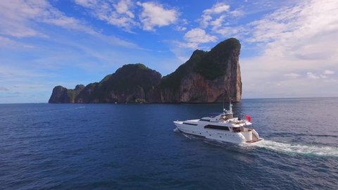 Luxury charter yacht cruising by islands