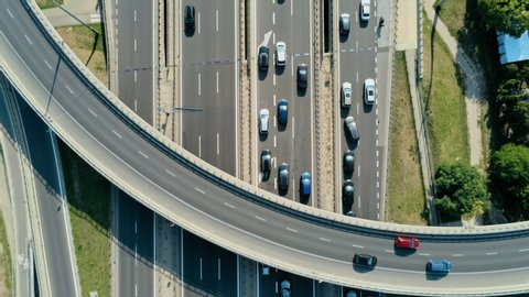 Transportation and Infrastructure: Highway Overpass and Junction with Cars, Trucks and Buses. Aerial View of Road Traffic Jam at Daytime Rush hour in Warsaw, Poland. 4K Close Up Fly Over shot