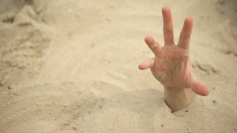 Hand sinking in quicksand, grasping stick to get out, tips to survive in desert