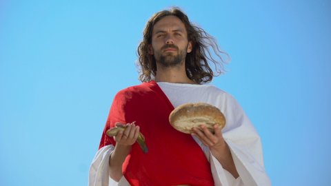 Jesus showing fish and bread, biblical story, miracle about feeding thousands
