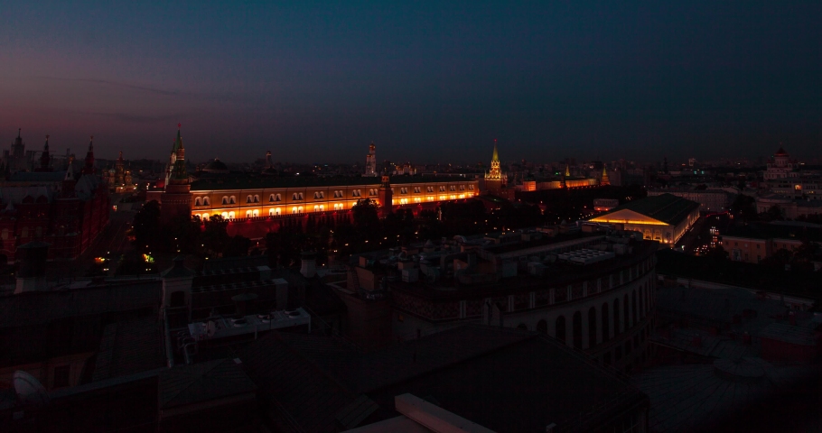 Time lapse of Moscow Kremlin and other buildings on the Red Square from night to day and around with people walking on the streets. Clear sky on the warm summer weather. Static view
