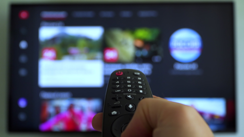 Male hand holding the TV remote control and turn off smart tv. Channel surfing, focused on the hand and remote control. Internet TV. Royalty-Free Stock Footage #1035136739