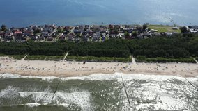 Beach Chalupy resort in Poland. Aerial video. Baltic Sea. People on towels. Waves