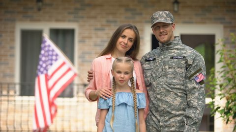 US military man with family showing keys from house, benefits in crediting
