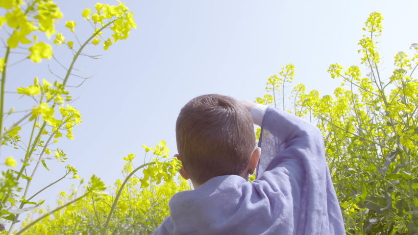 Young boy looking at an airplane flying-by 