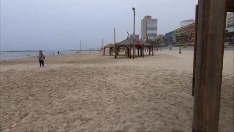 Tel Aviv / Israel - 02 13 2018: People are walking and doing sports on the seaside, there are captions and vehicles around