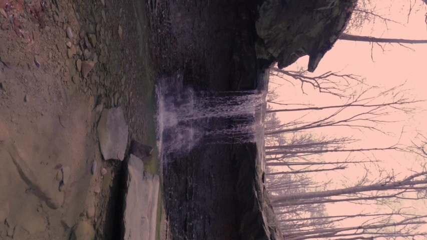 Blue Hen Falls in the Cuyahoga Valley National Park. Natural falling water over shale hitting the rocks below. Park of the Cuyahoga River watershed as a tributary. Vertical Video, turn 90 degrees.