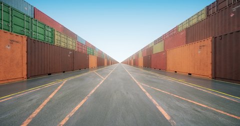 Endless rows of cargo shipping containers under blue sky. Camera moves slowly along stacked cargo containers painted in colors of different freight transportation business companies. Seamless loop.