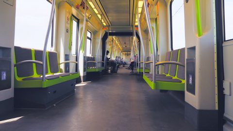 VALENCIA / Spain - 05 26 2019: Travelling with an almost empty metro train, overground on a sunny day, 4k view inside