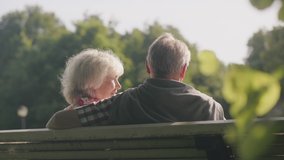 Senior couple getting to know each other on a park bench while looking for a partner in the summer - Powered by Shutterstock - Get 15% off with code: PIKWIZARD15