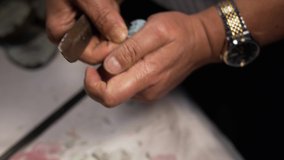 Removal of cast plaster parris from the denture (artificial jaw) bast heat cured RPD in 4k. Artificial teeth cleaing of excess materials. - Powered by Shutterstock - Get 15% off with code: PIKWIZARD15