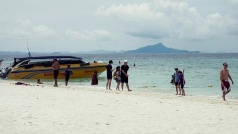 Krabi , Krabi / Thailand - 05 29 2019: Travelers travel to the island by boat to see the beauty and sunbathing at the beach front, with a long beach, suitable for swimming at Krabi in Thailand. Slow m