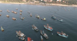 Top view, aerial view fishing harbor market from a drone. Royalty high-quality free stock video footage of market at Mui Ne fishing harbour or fishing village. Fishing harbor is a popular travel