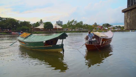 Kuching , Sarawak / Malaysia - 05 15 2019: Boats docking and departing in Kuching