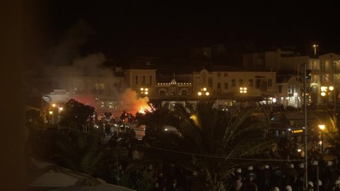 Mytilene / Greece - 04 22 2018: Far Right Fascists burn bins and firing flares while Afghan refugees peacefully demonstrating in Sappho Square Lesbos