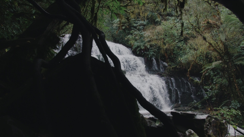 Amazing Waterfall in New Zealand. Falling water hitting water surface. 
