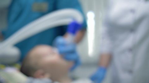 general anesthesia, patient is in a state of sleep after inhaling into mask for anesthesia in operating room for treatment, the form is not in focus