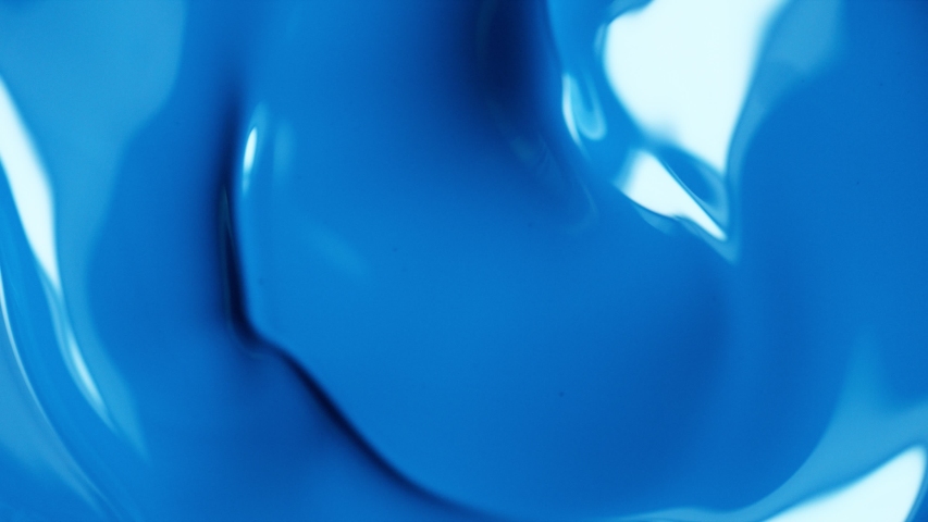 Super slow motion of mixing blue paint. Abstract background.