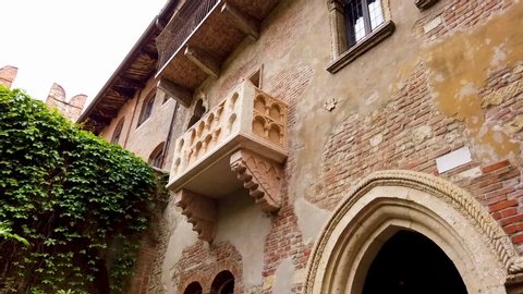 Verona / Italy - 05 16 2019: Patio and balcony of Romeo and Juliet house at golden sunset, Verona, Italy