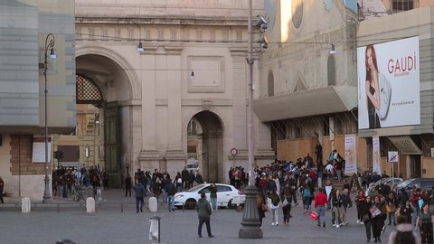 Rome / Italy - 03 29 2019: Tourists traffic at the northern gate of the Aurelian Walls entrance of piazza del popolo. Leonardo da Vinci museum in the background